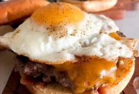 Blackstone Burger with Crispy Fried Egg and Caramelized Onions