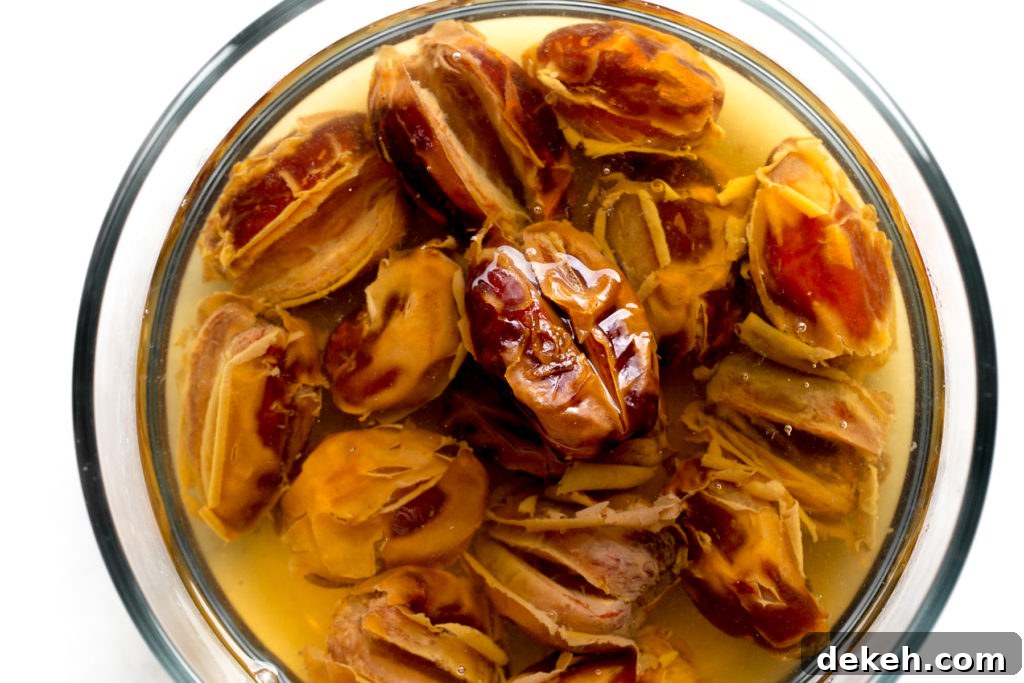 medjool dates soaking in water with white background