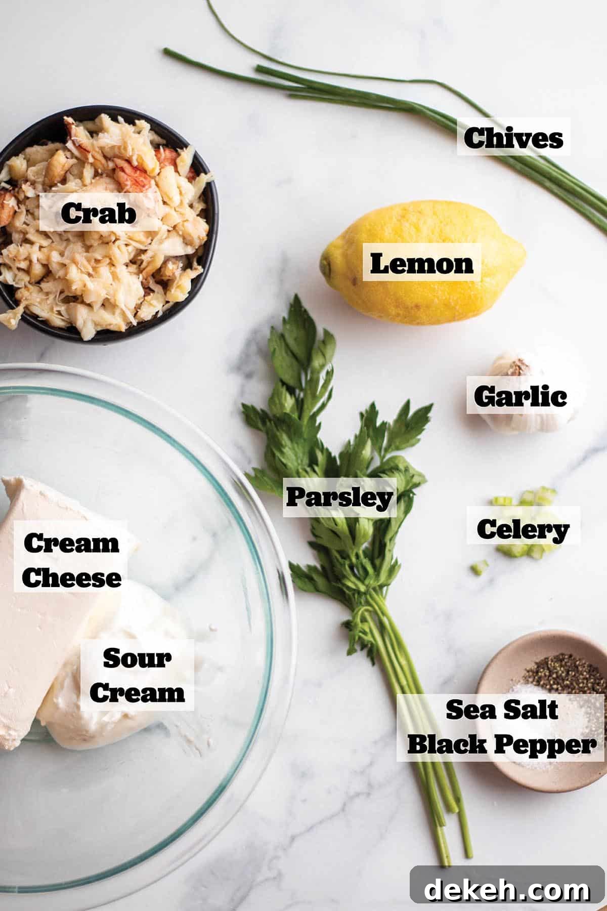 Creamy Chilled Crab Dip Recipe for Parties and Appetizers 3 Ingredients to make a crab dip. A bowl of fresh crab, fresh chives and parsley, cream cheese, sour cream, salt & pepper, garlic, celery and lemon.