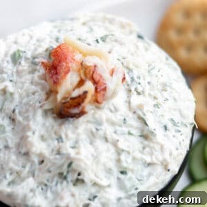 Creamy Chilled Crab Dip Recipe for Parties and Appetizers 10 A bowl of fresh crab dip with cream cheese and a lump of fresh crab meat on top.