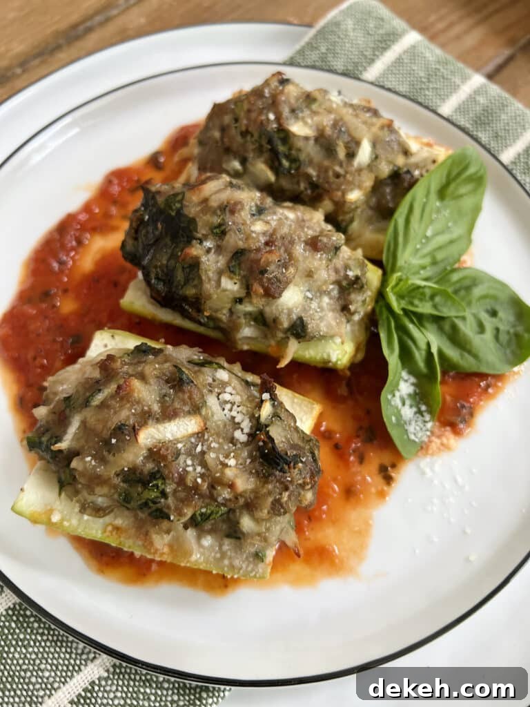 Three pieces of Baked Stuffed Cucuzza Squash over tomato sauce on white plate with basil sprig garnish.