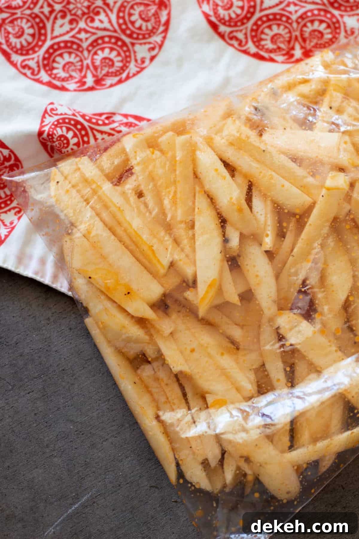 Ziplock bag filled with cut potatoes and seasonings to make air fryer french fries.