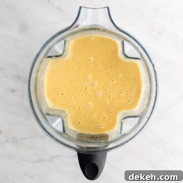 Blended soup in a blender jar before adding the broccoli and vegan cheese.