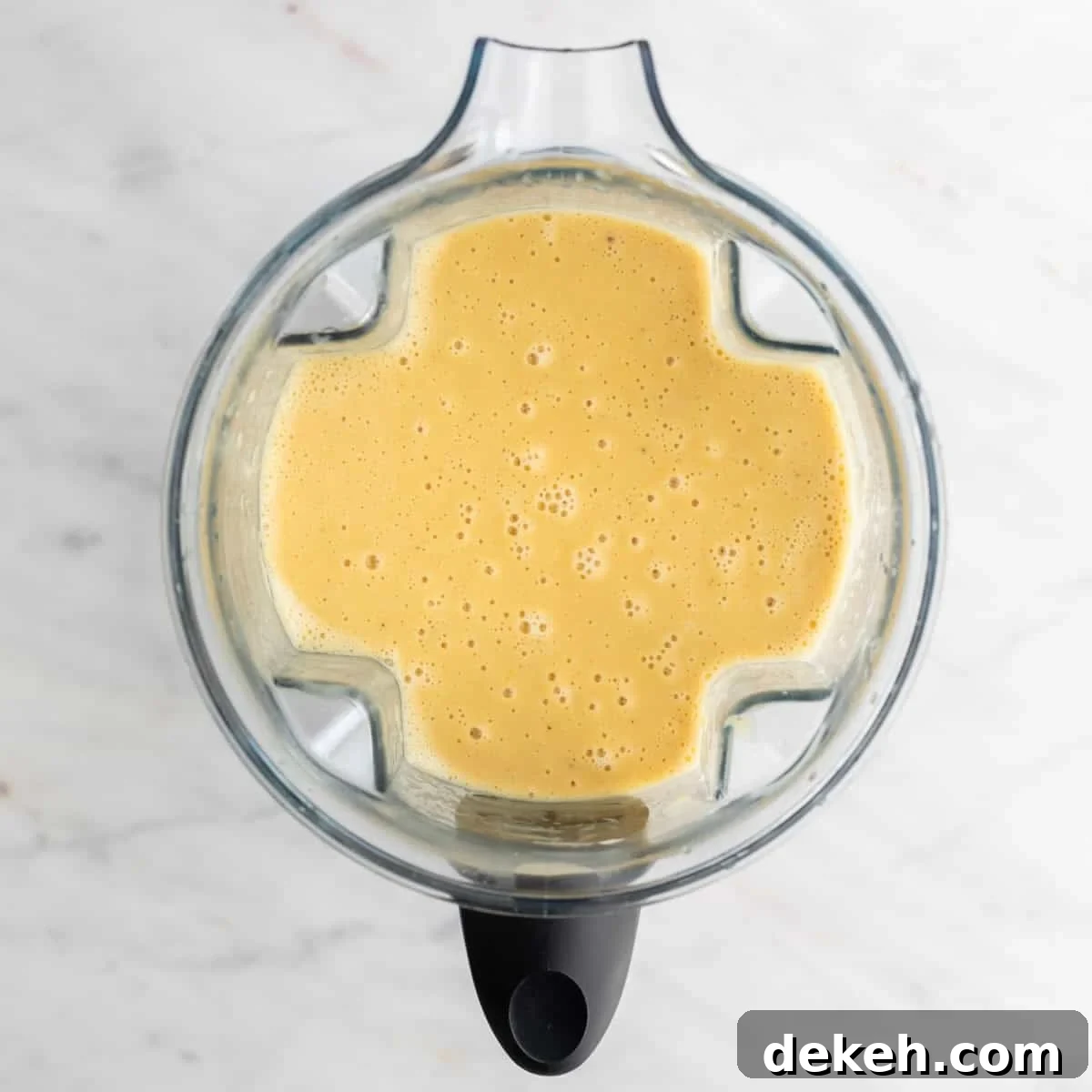 Blended soup in a blender jar before adding the broccoli and vegan cheese.