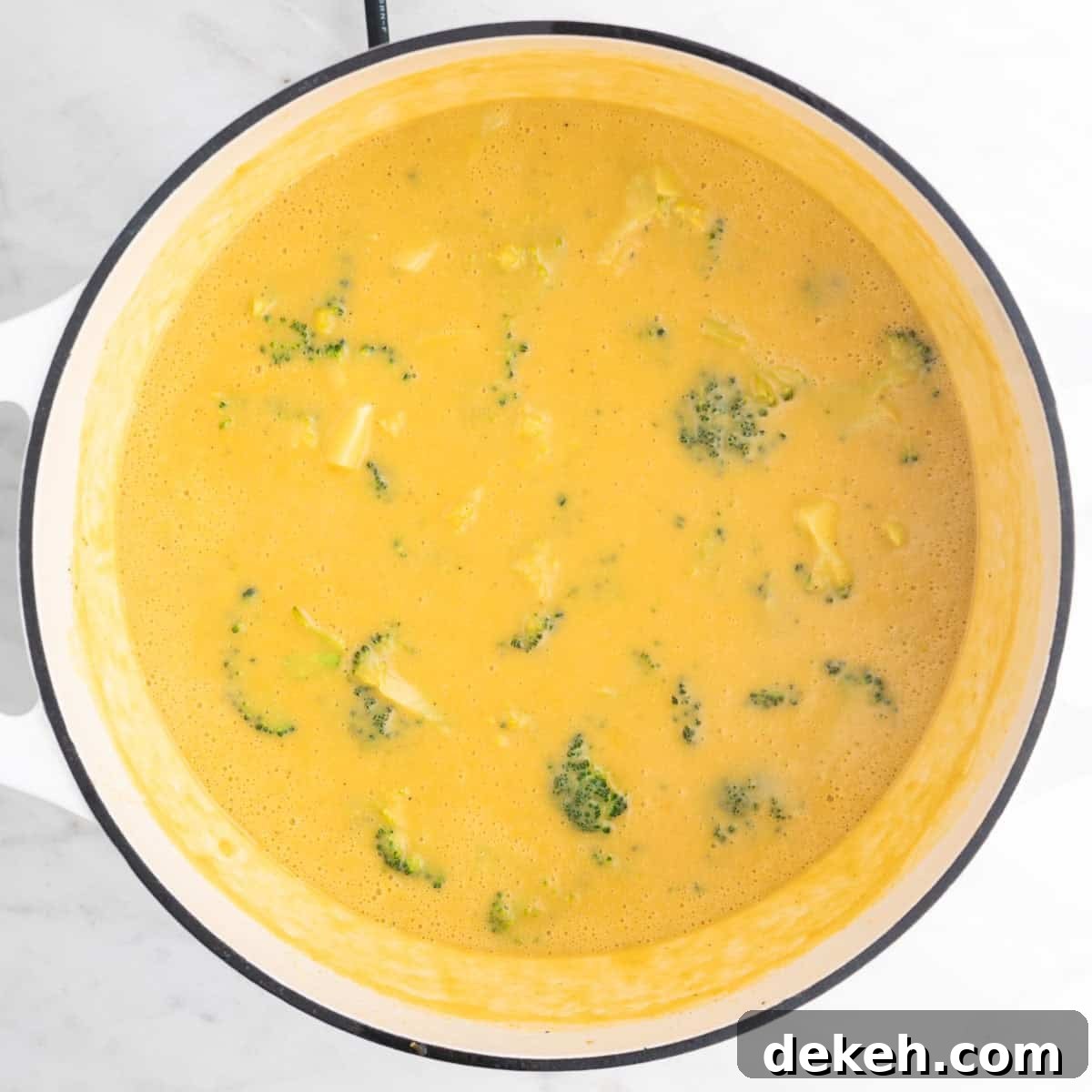 Vegan broccoli cheddar soup in a large pot fully cooked.