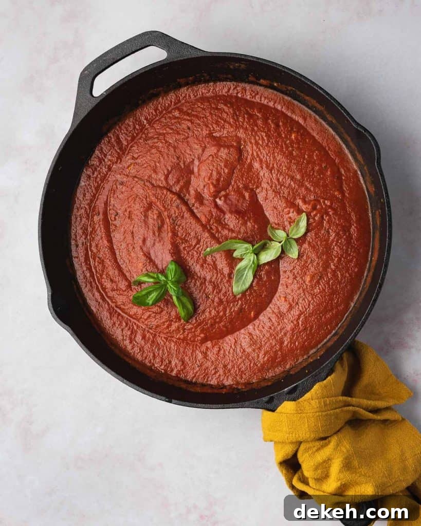Basil added to tomato sauce.