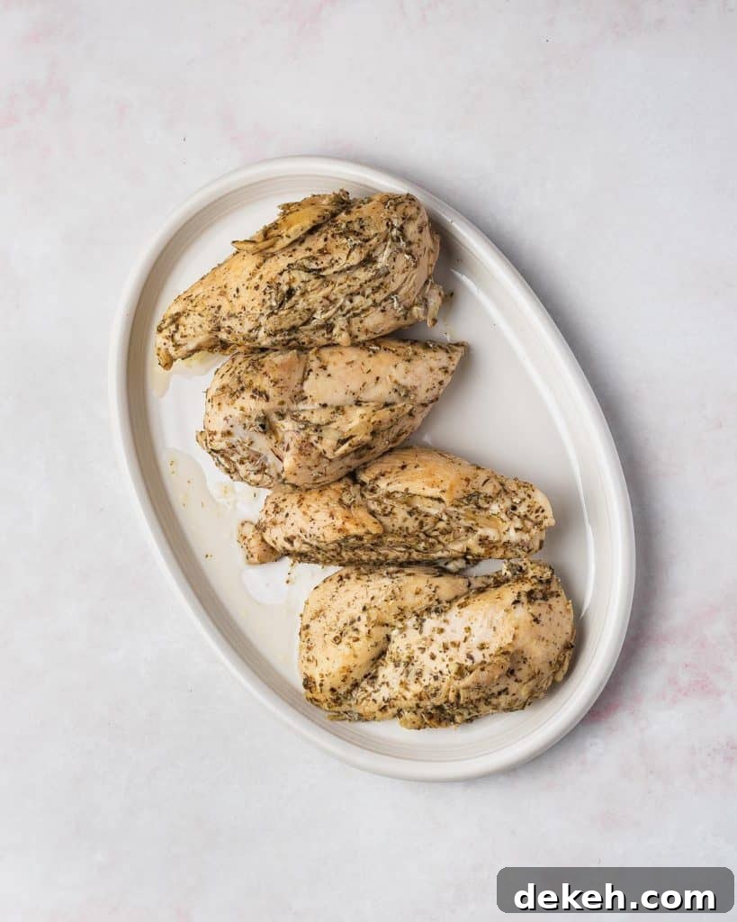 Cooked chicken breasts set aside.
