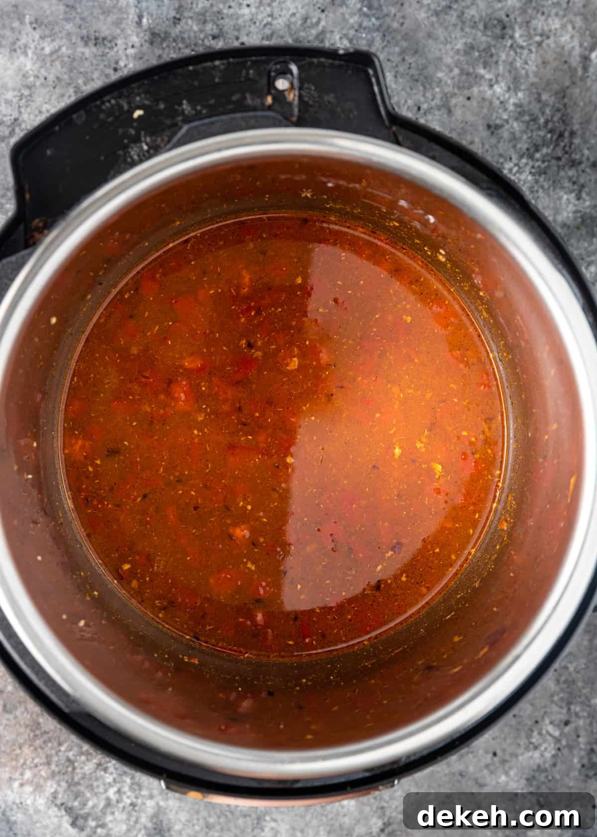 overhead: vegetables and stock in instant pot for black chickpea curry