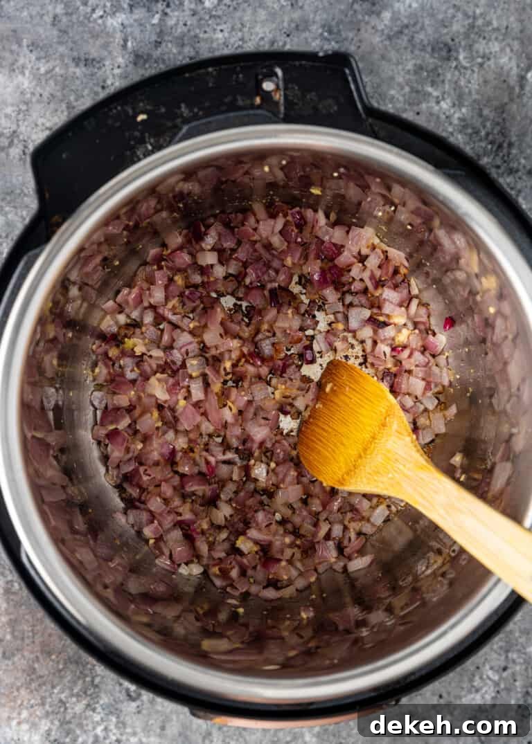 overhead: tempered spices and red onion in instant pot