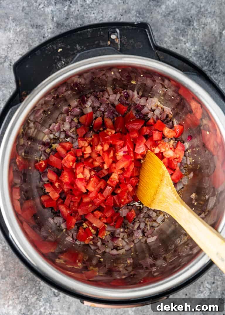 overhead: chopped tomatoes with red onion in instant pot