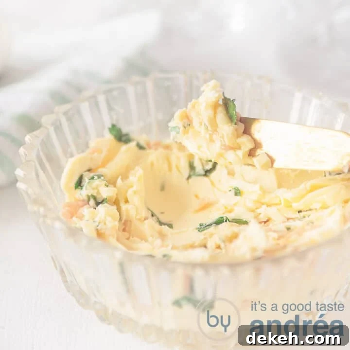 Glass bowl of easy garlic herb butter with a gold knife