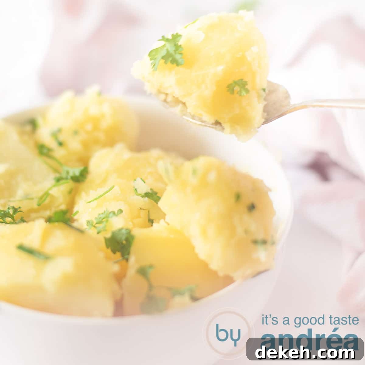 White bowl of boiled potatoes with parsley and chives