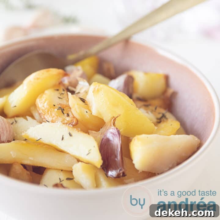 Roasted potatoes with garlic and thyme in a pink bowl