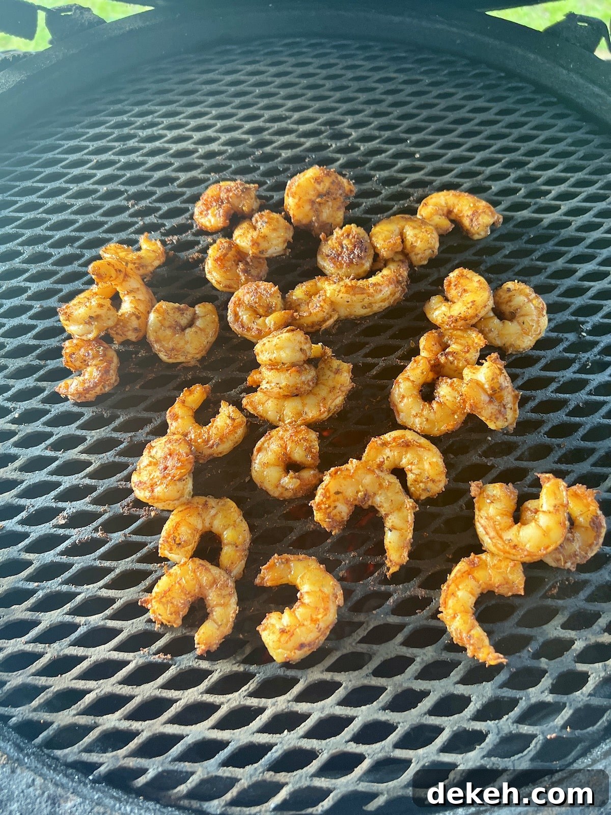 Grilling shrimp on a big green egg grill.