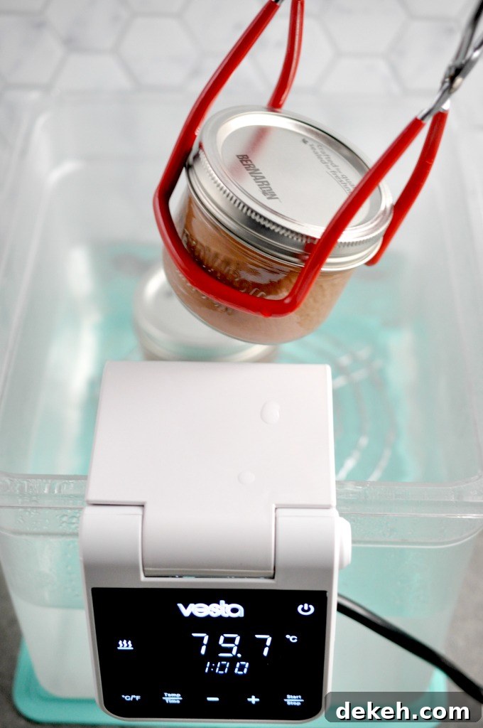 Jars of chocolate coffee pots de creme  being placed in  a sous vide water bath to cook | I Sugar Coat It