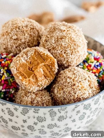 Dulce de leche truffles with coconut and sprinkles piled inside a grey bowl.