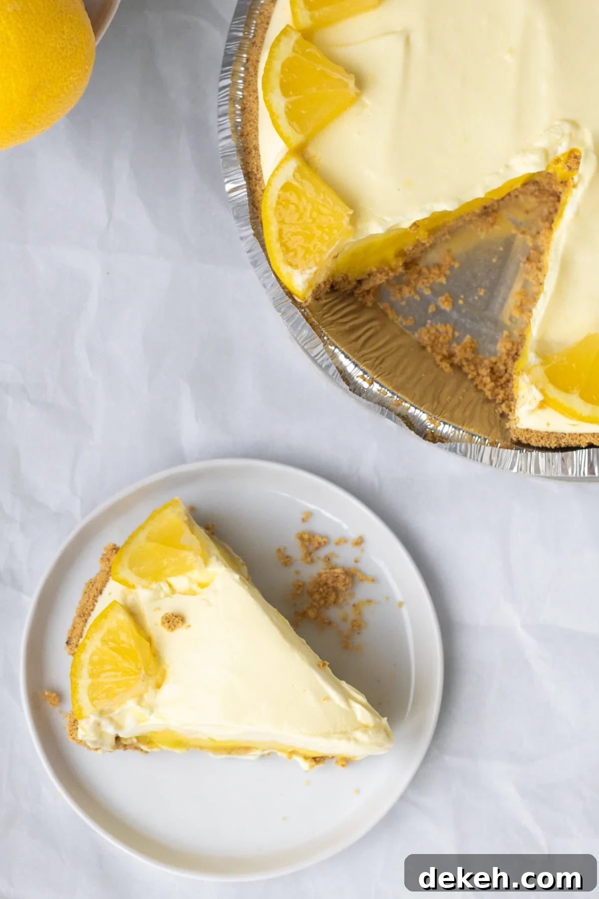 a piece of lemon pudding pie cut from a whole pie