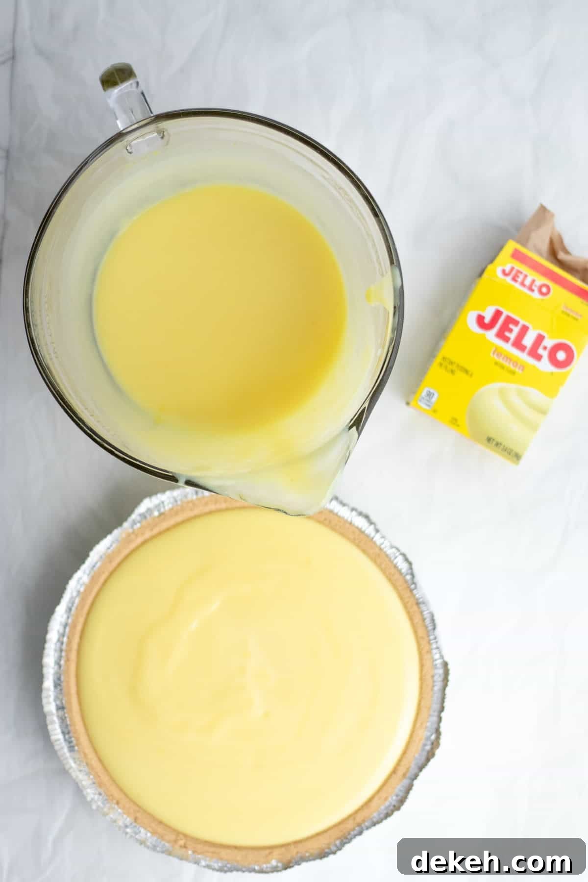 pudding being poured into a pie crust