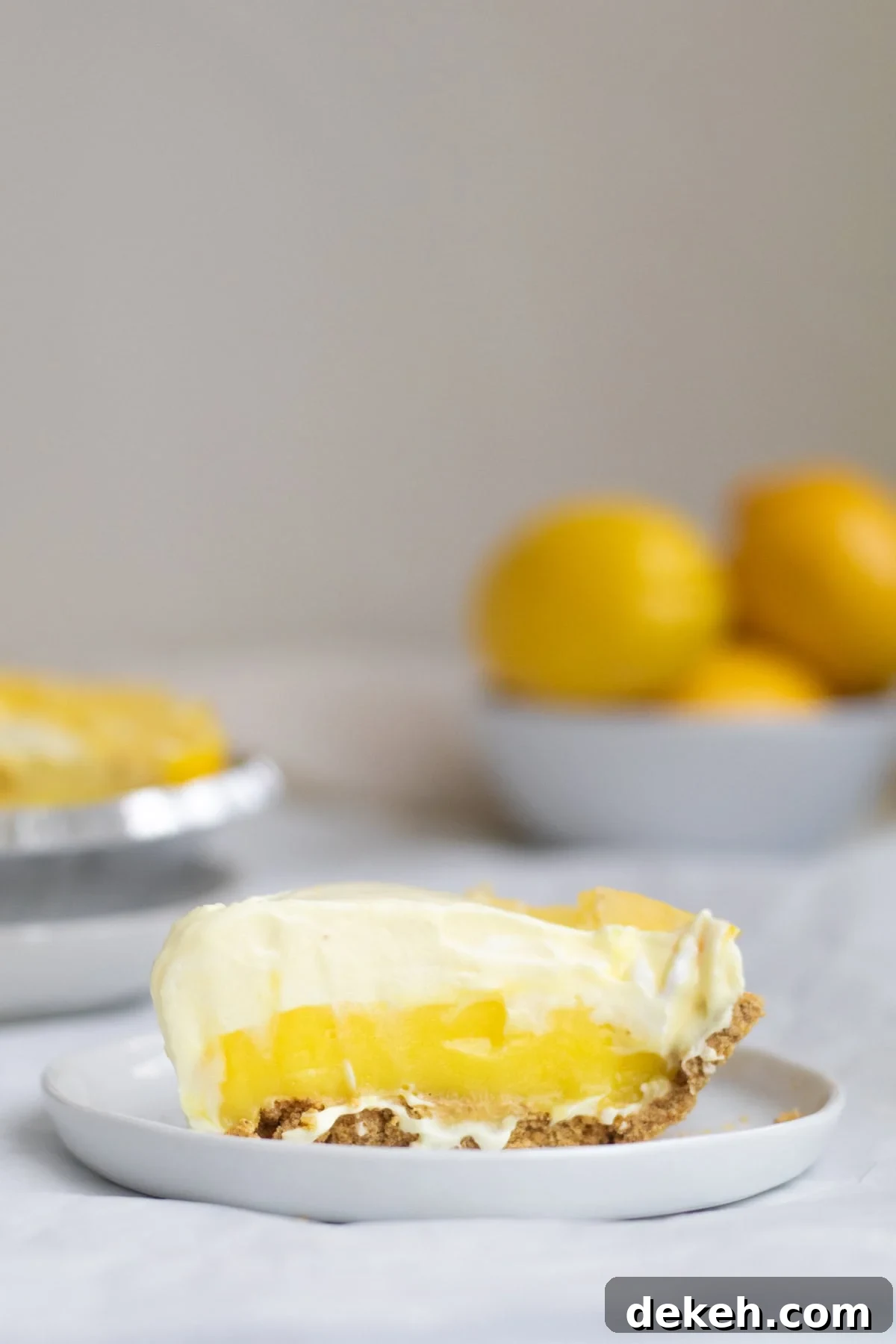 piece of lemon pudding pie on a white plate
