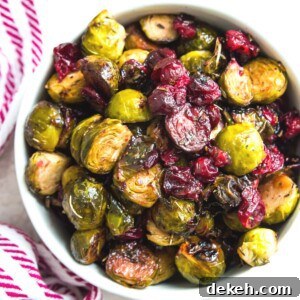 A bowl of roasted Brussels sprouts with cranberries.