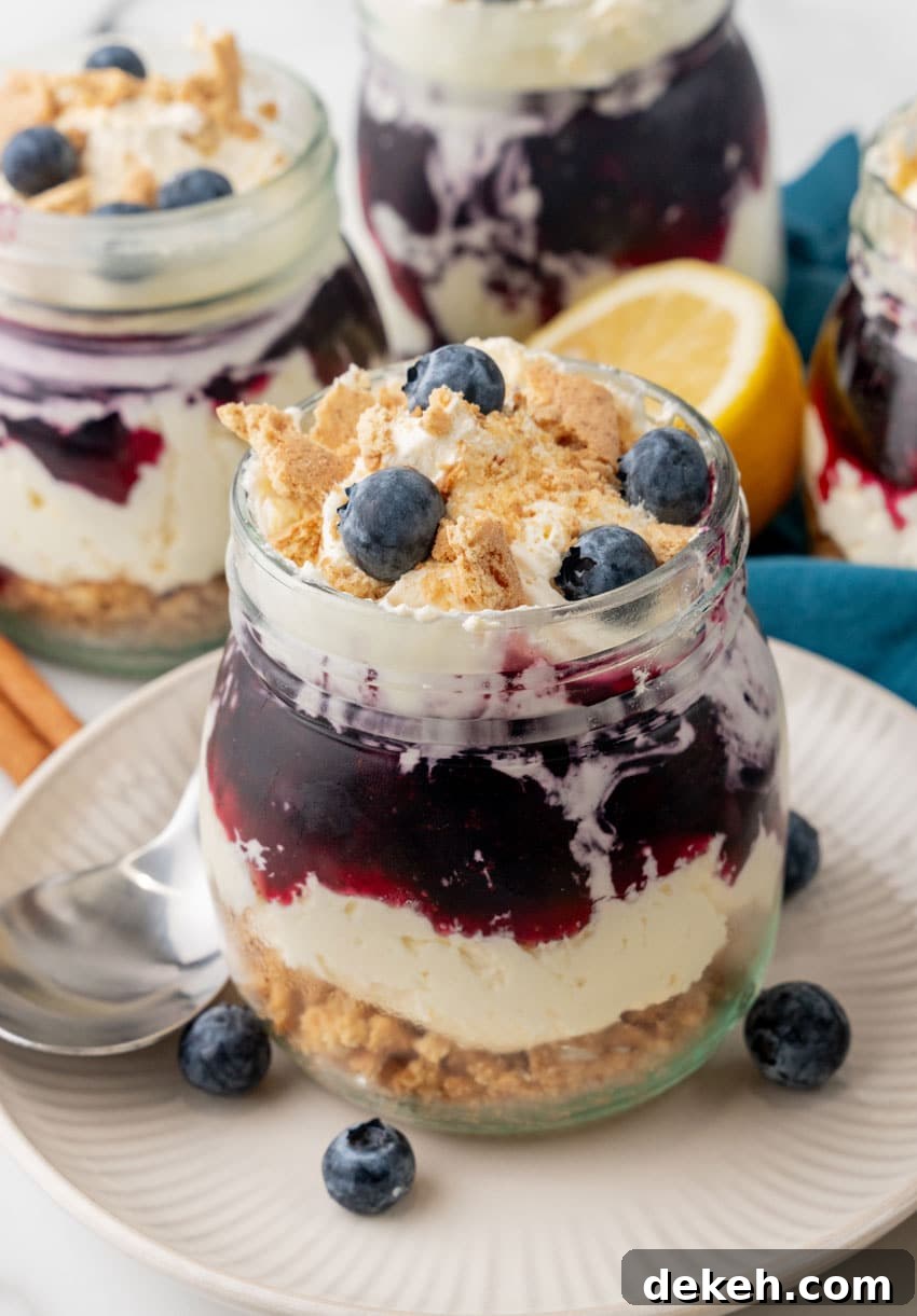 blueberry cheesecake jars on white plates