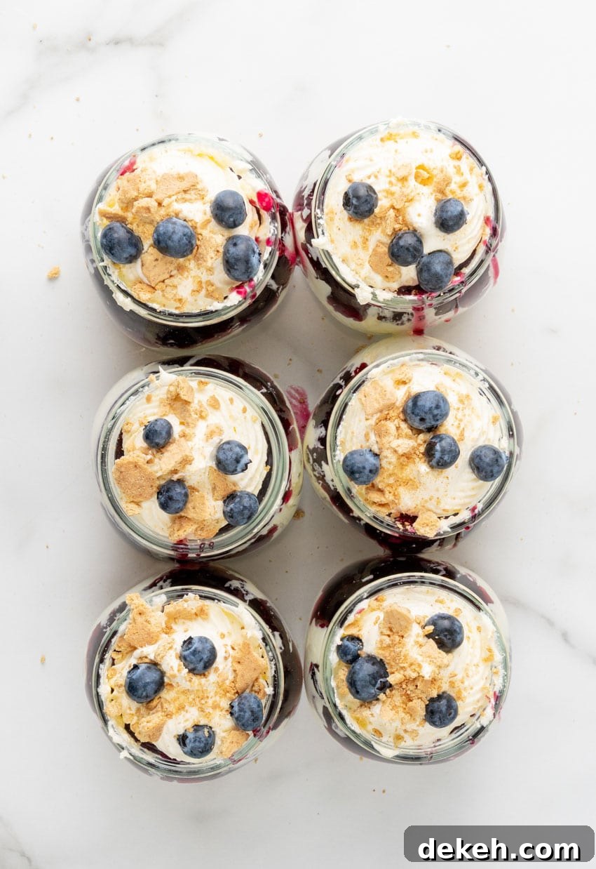 blueberry cheesecake jars arranged in two rows on a marble countertop