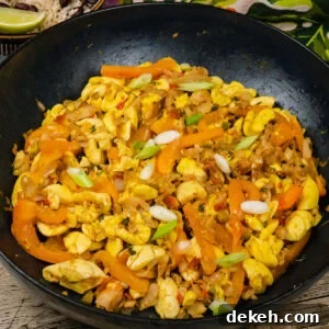 Ackee and Saltfish in a cast iron pan with chopped fresh spring onion sprinkled over the top