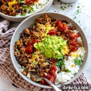 Grey bowl with taco rice in it and guac on top.