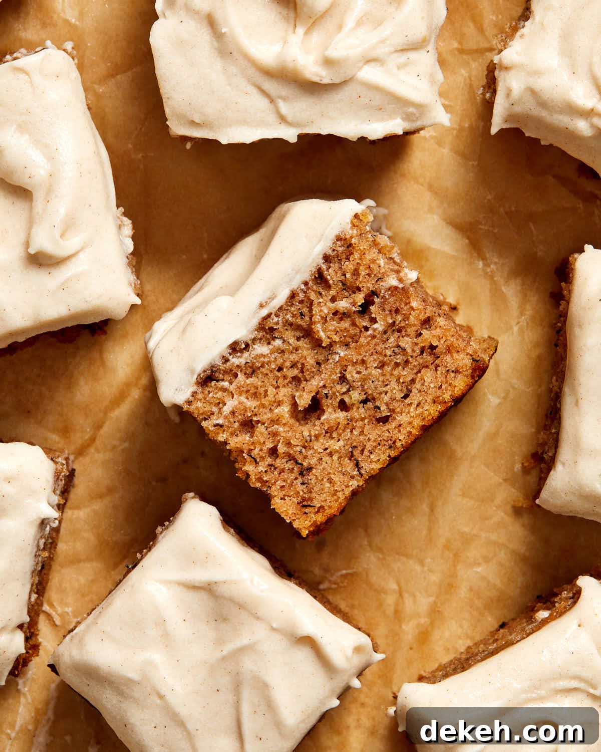 Piece of cake turned on its side on brown parchment paper.