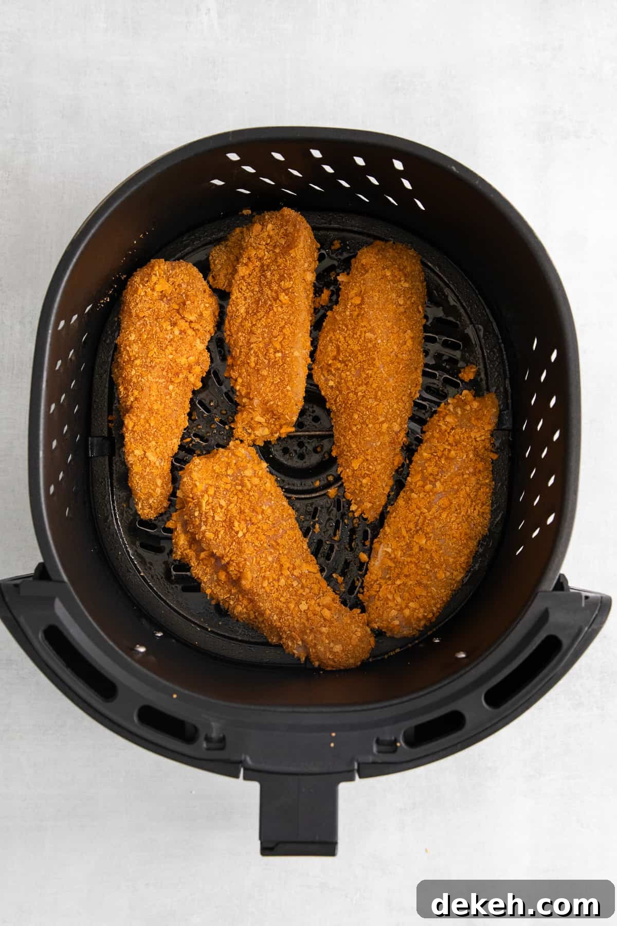 Cheez-it breaded chicken fingers in an air fryer.