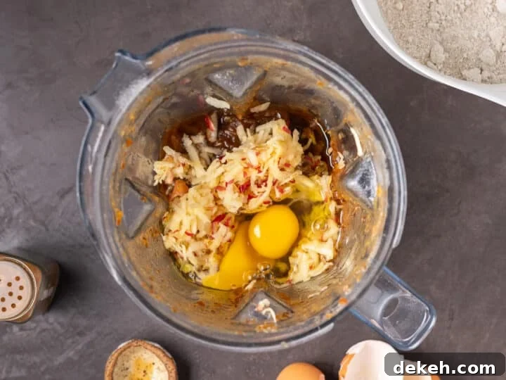 remaining wet ingredients added to the blender, grated apple, eggs and avocado oil