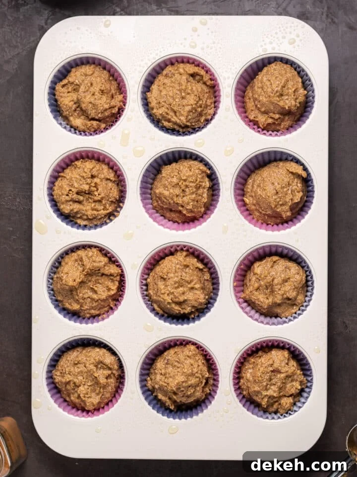 muffin tin filled with date muffin batter