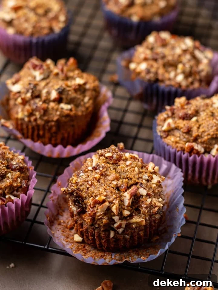 close up view of a date muffin with pecan topping