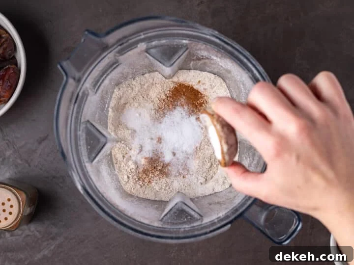 baking soda and cinnamon added to oat flour in a blender