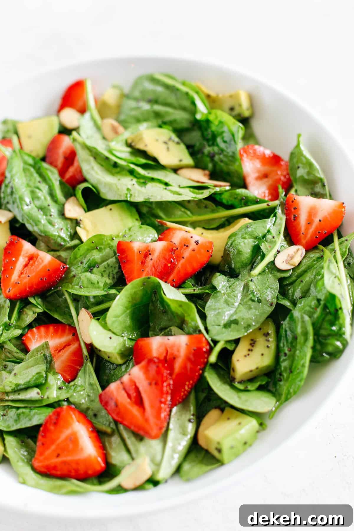Super simple Strawberry Spinach Salad with Poppy Seed Dressing that is healthy, delicious and the perfect summer staple!