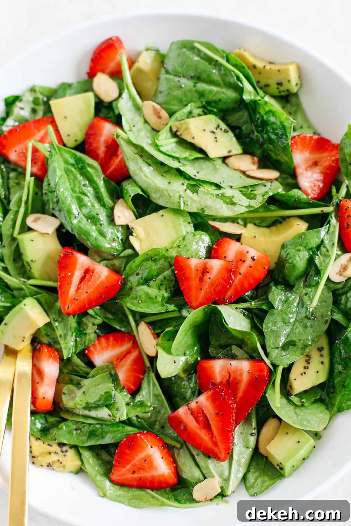 Super simple Strawberry Spinach Salad with Poppy Seed Dressing that is healthy, delicious and the perfect summer staple!