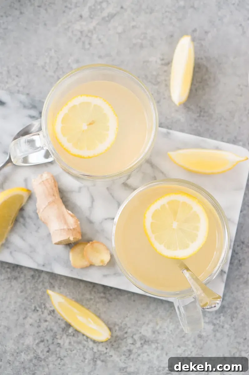 two ginger lemon tea with lemon slices in glass mugs