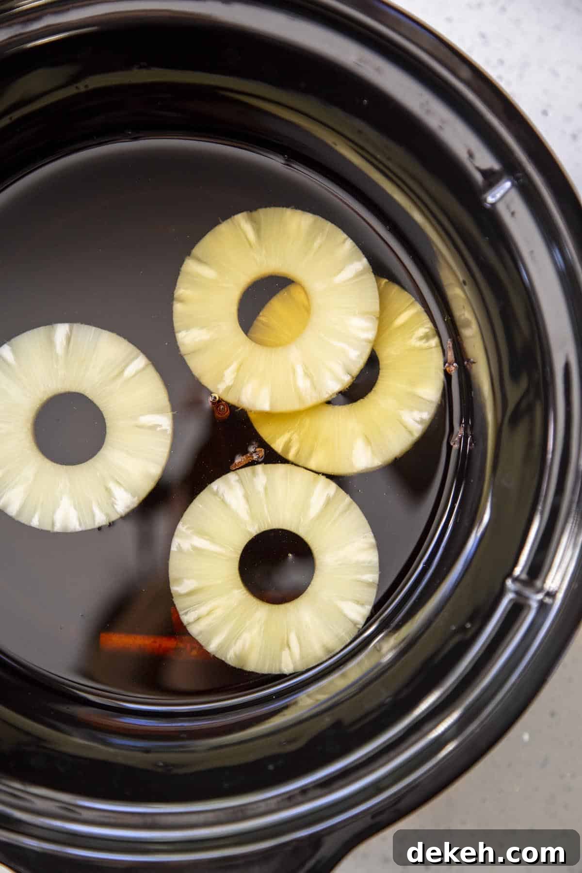 All ingredients for crockpot apple cider in the slow cooker.