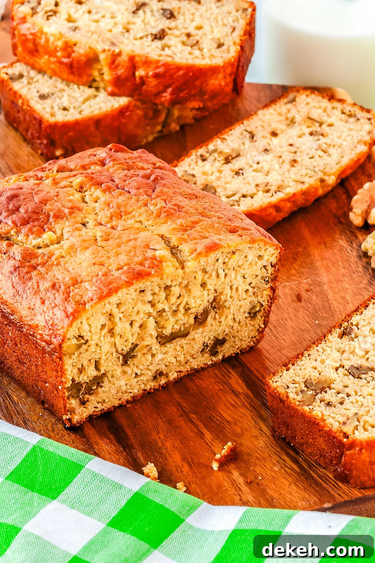 A loaf of banana bread cut with slices all around it.
