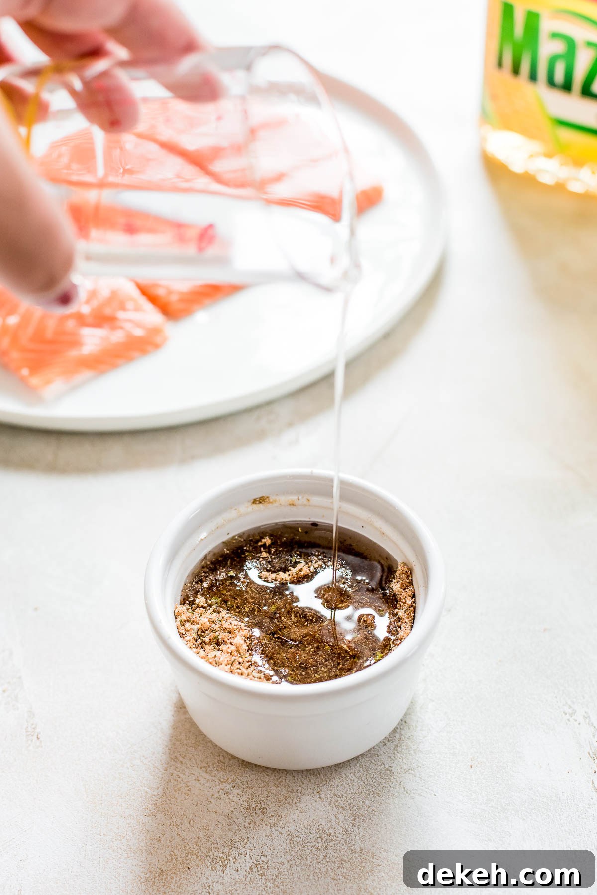 oil being drizzled into marinade cup