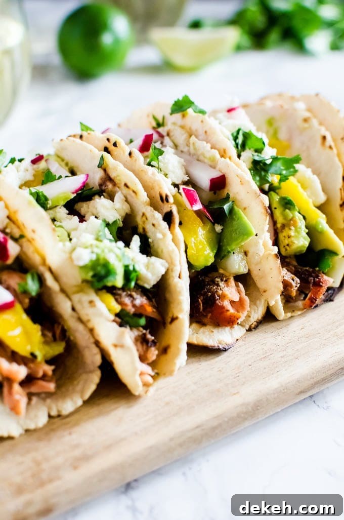 Grilled salmon tacos with a refreshing avocado mango salsa.