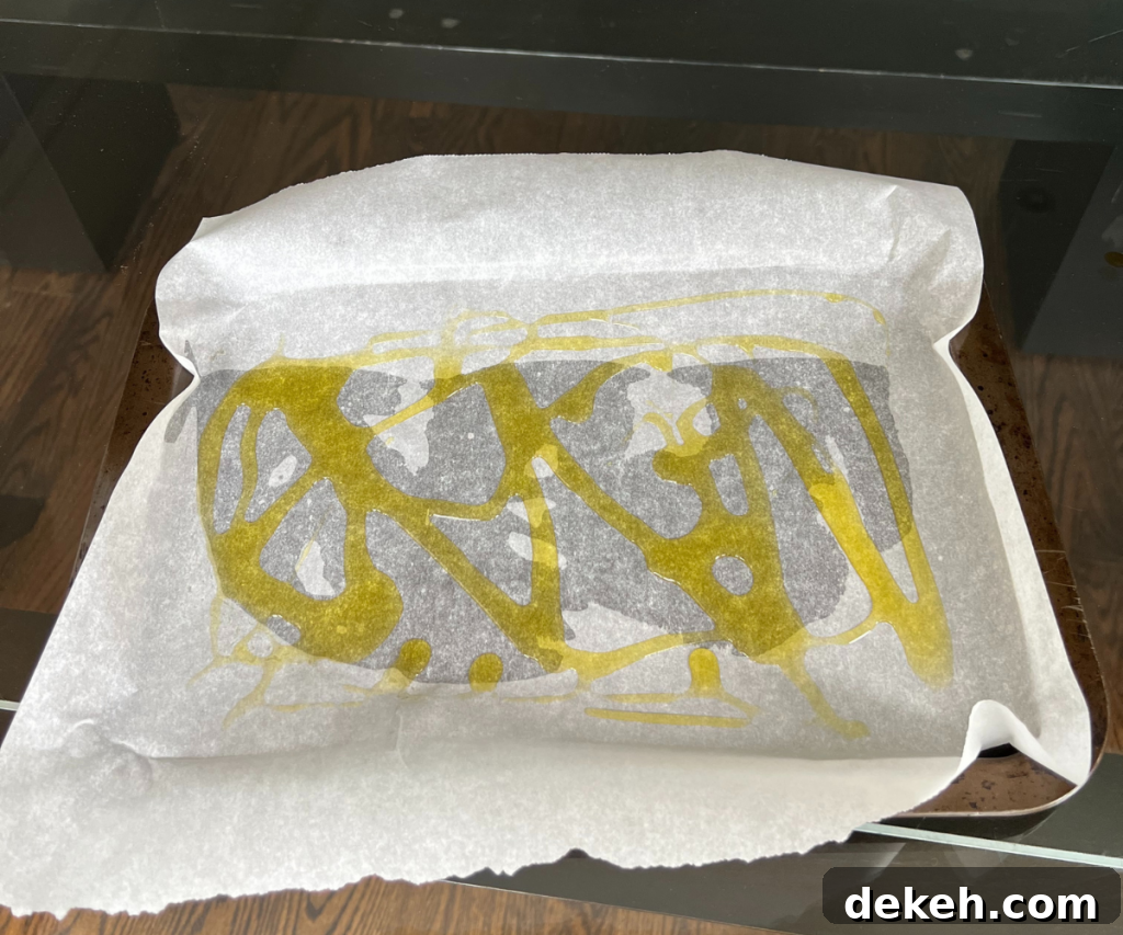 Olive oil in-between parchment and pan