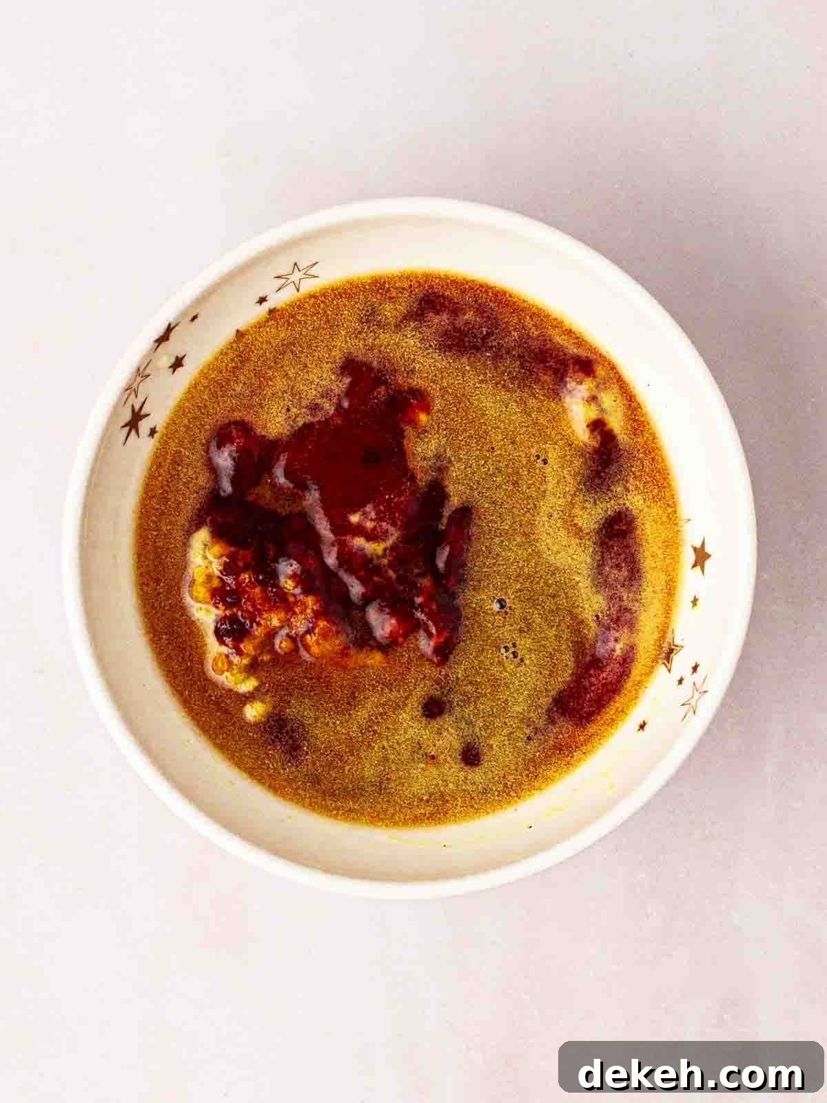 A bowl of BBQ sauce ingredients to be mixed to add to slow cooker beef brisket.