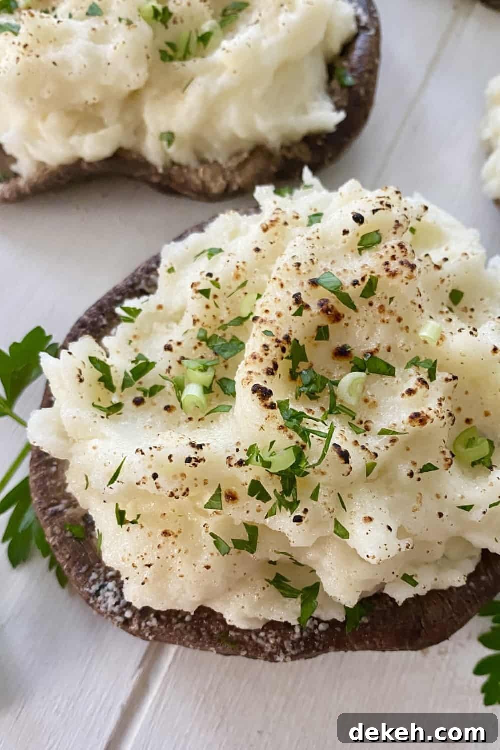 A meatless entree of a mashed potato stuffed portobello mushroom.