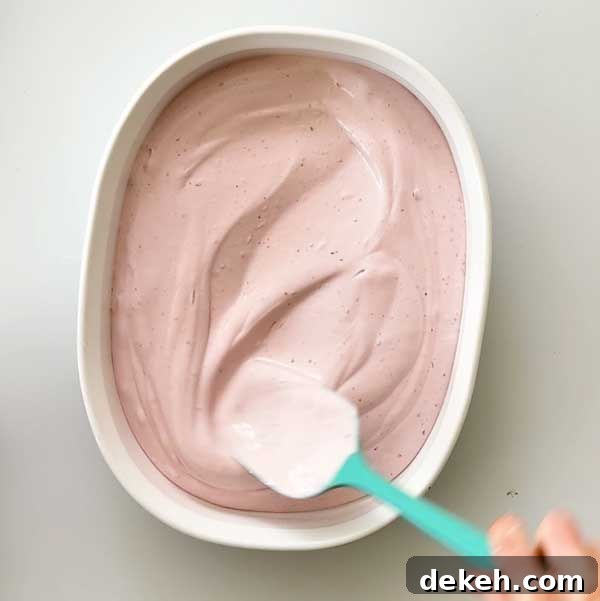 Spreading ice cream in a shallow dish.
