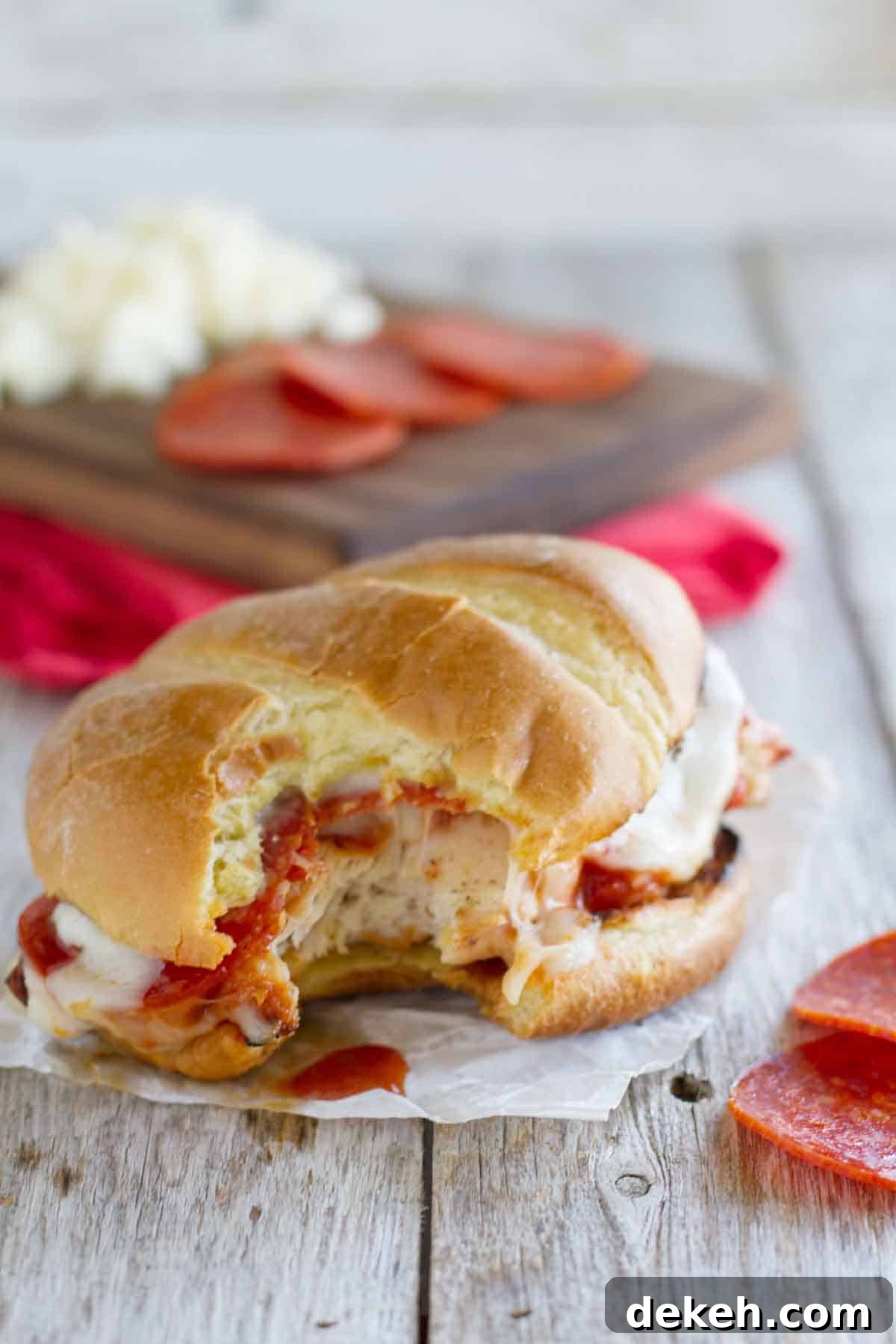 Pizza Topped Grilled Chicken Sandwich with a bite taken from it