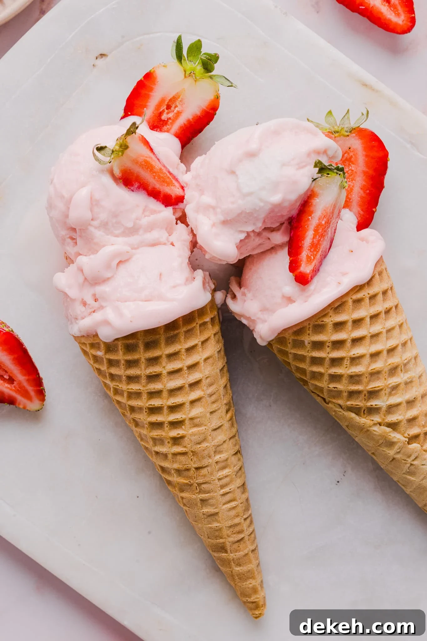Strawberry ice cream in sugar cones.