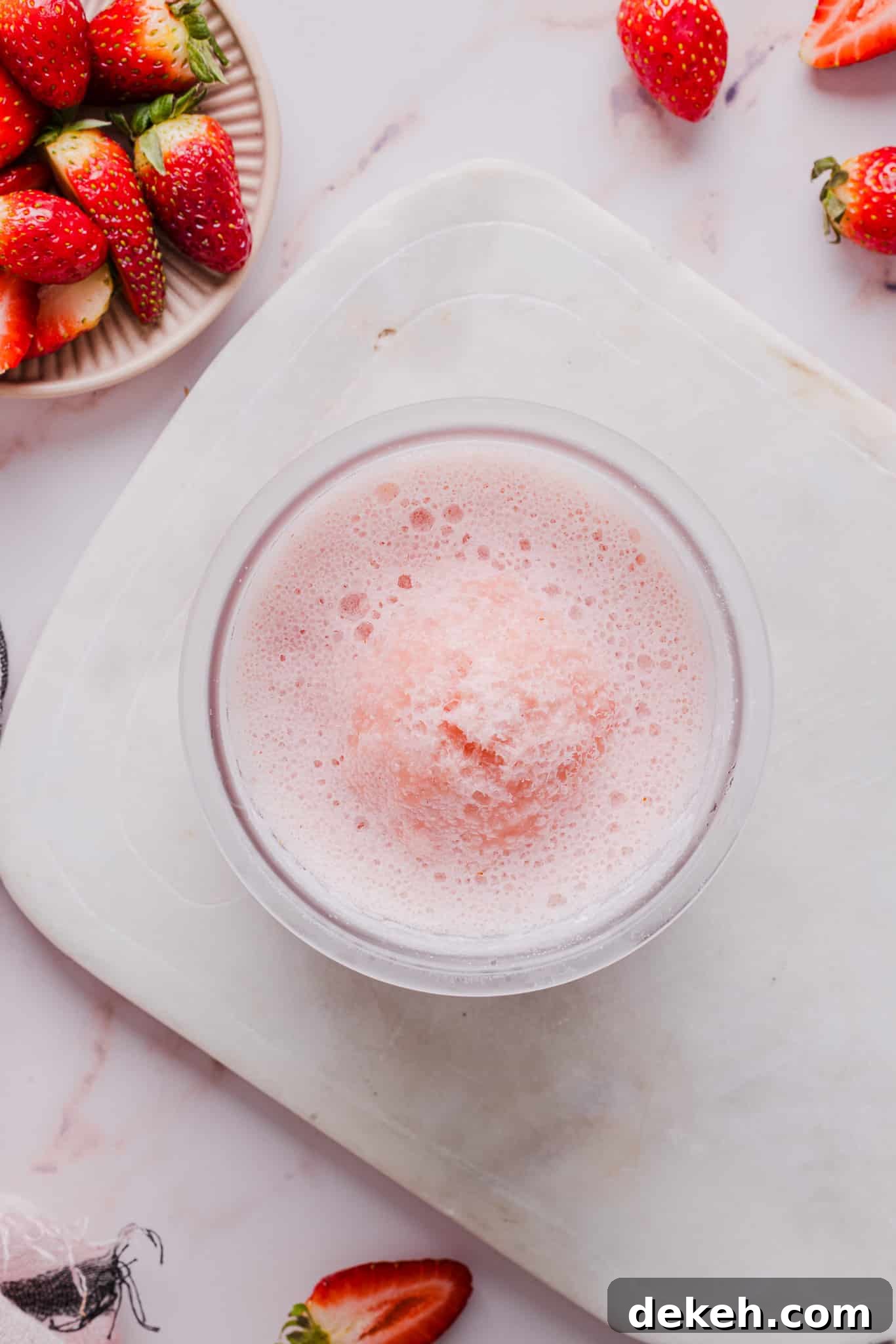 Ingredients for strawberry ice cream blended together and then frozen in a Ninja Creami pint container.