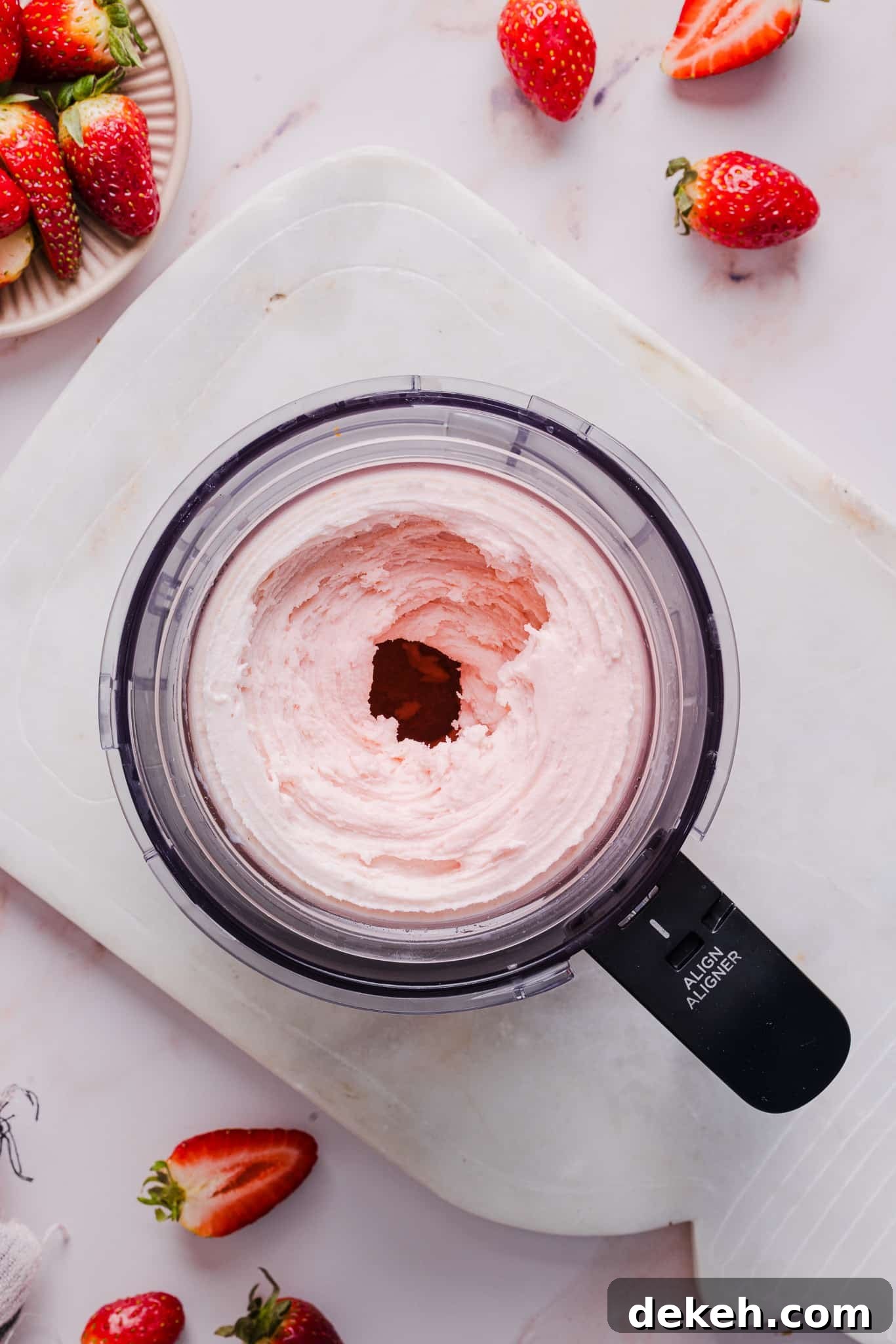 Strawberry ice cream in a Ninja Creami machine.