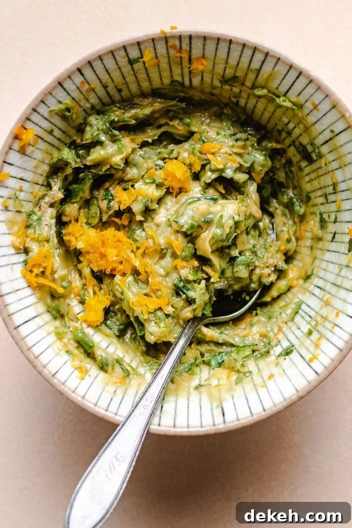 Photo shows the herb lemon butter mixed with fresh herbs in a small bowl